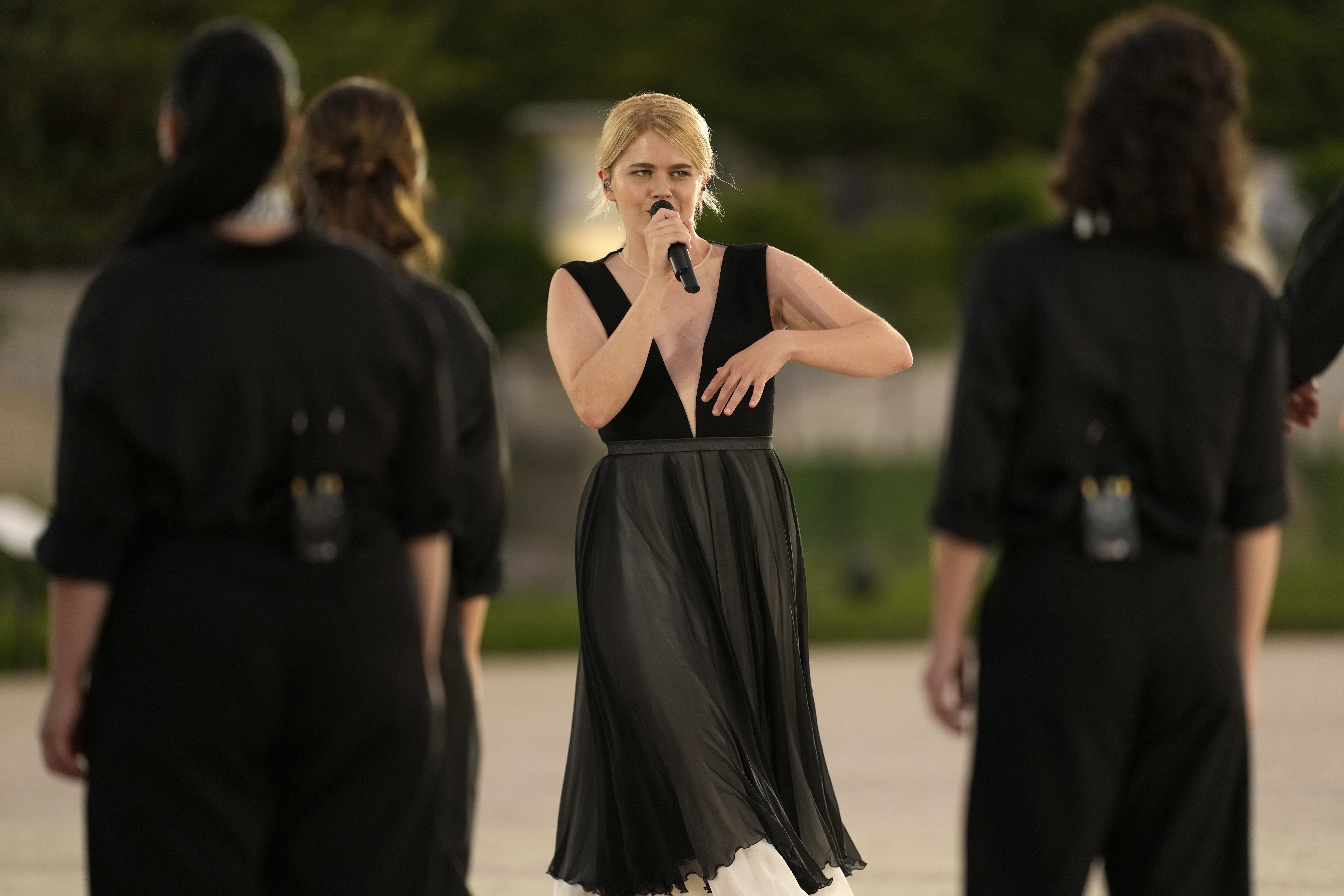 French musician Zaho de Sagazan, inside the Tuileries Garden in Paris, opens the ceremony by performing 'Sous le Ciel de Paris,' which translates to 'Under the Paris Sky.'