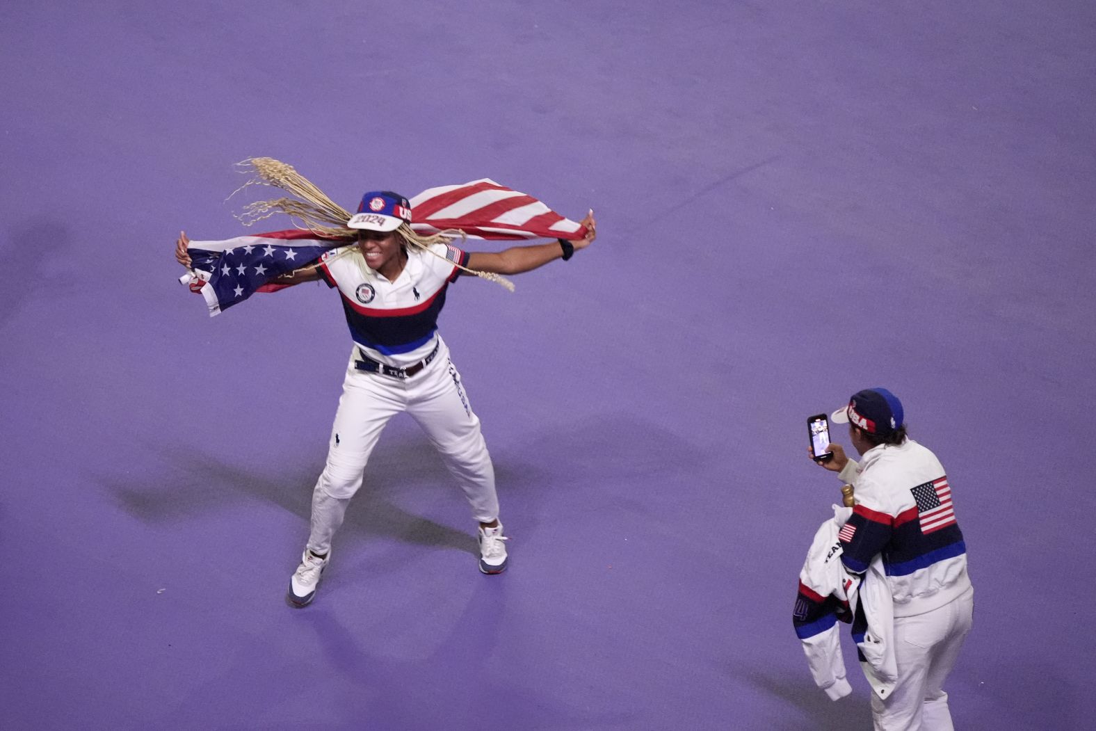 An American athlete is filmed during the parade.