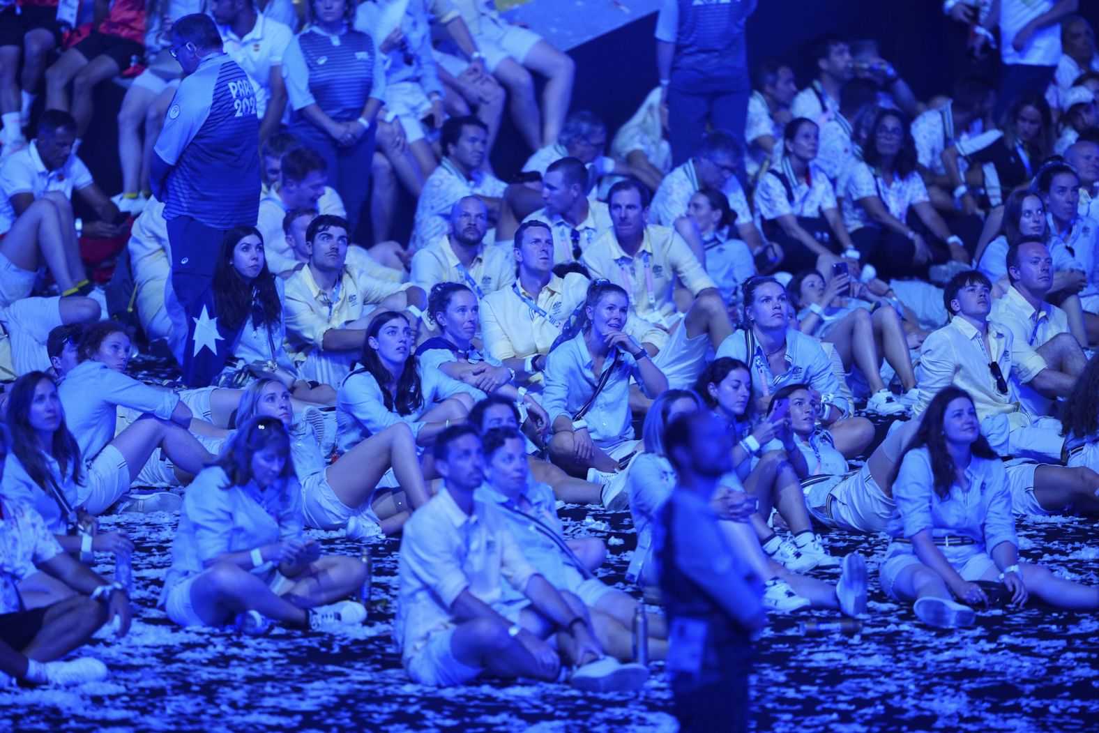 Athletes watch the ceremony from the floor of the Stade de France.