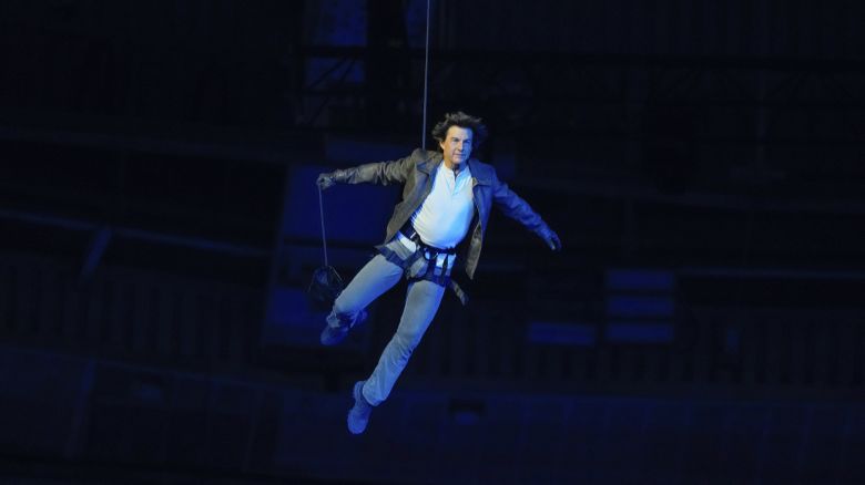 Tom Cruise is lowered on the State de France during the 2024 Summer Olympics closing ceremony, Sunday, Aug. 11, 2024, in Saint-Denis, France. (AP Photo/Natacha Pisarenko)