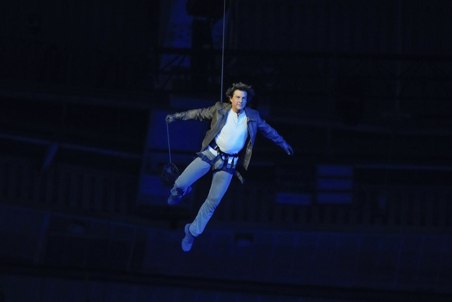 Cruise is lowered onto the floor of the Stade de France after jumping off the stadium's roof.