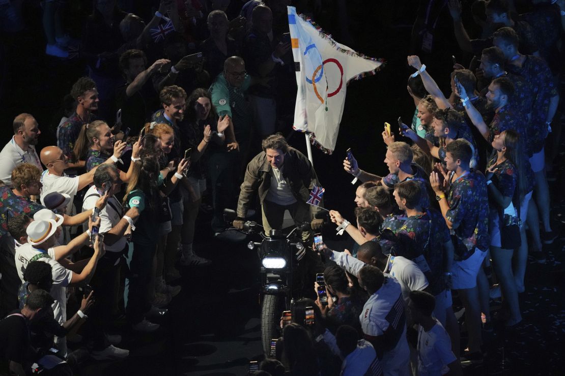 Tom Cruise rides a motorbike during the 2024 Summer Olympics closing ceremony.