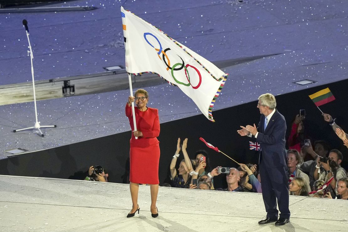 Karen Bass, Mayor of LA, wore a red dress from US designer Sergio Hudson's Fall-Winter 2024 collection as she waved the Olympic flag next to Thomas Bach, President of International Olympic Committe (IOC) during the closing ceremony.