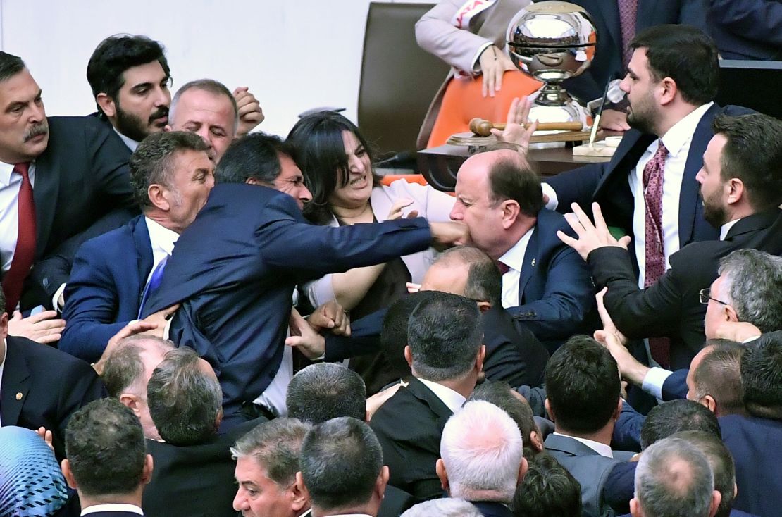 Turkey's ruling AK Party lawmakers scuffle with opposition lawmakers during the extraordinary session of the Turkish Grand National Assembly to debate the case of jailed opposition lawmaker Can Atalay, in Ankara, Turkey, Friday, Aug. 16, 2024.