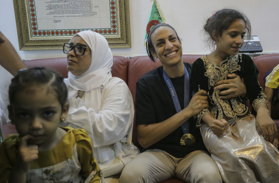 Imane Khelif, second from right, smiles as she arrives home after returning from the 2024 Paris Olympic Games in Tiaret, Algeria on Friday.