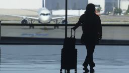 A holiday traveler looks out at a airplane at Salt Lake City International Airport, in Salt Lake City, July 3, 2024.