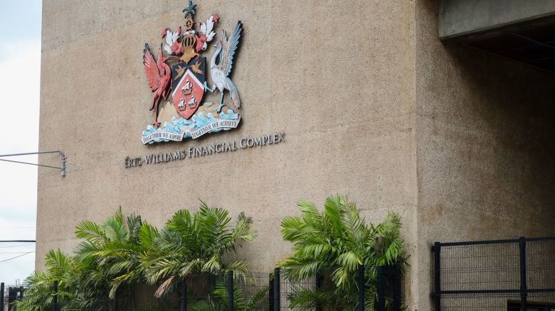 The country's coat of arms hangs on the facade of a government building in Port-of-Spain, Trinidad and Tobago, Tuesday, Aug. 20, 2024. Prime Minister Keith Rowley announced on Sunday, Aug. 18, 2024, that the country is redrawing the island's coat of arms to remove references to European colonization, replacing Christopher Columbus' three ships with the steelpan, a popular percussion instrument. (AP Photo/Ash Allen)