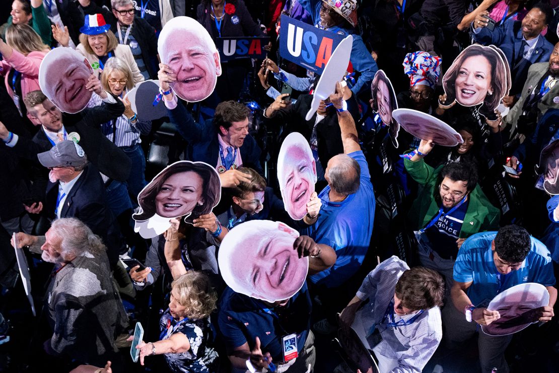 Members of the Georgia delegation wave photos of Vice President Kamala Harris and Minnesota Governor Tim Walz in Chicago on August 20.