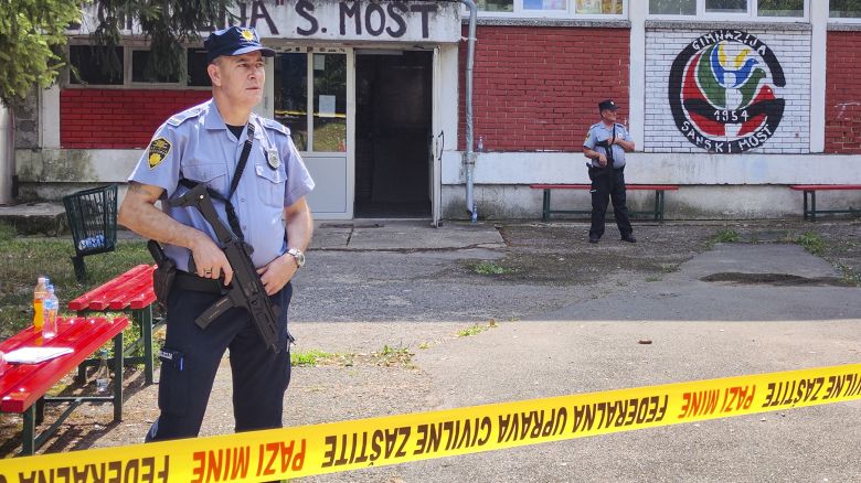 Police officers stand in front of a secondary school building in Sanski Most, northwest of Bosnia's capital, Sarajevo, Wednesday, Aug. 21, 2024, after a school employee shot and killed three people. (AP Photo/Edvin Zulic)