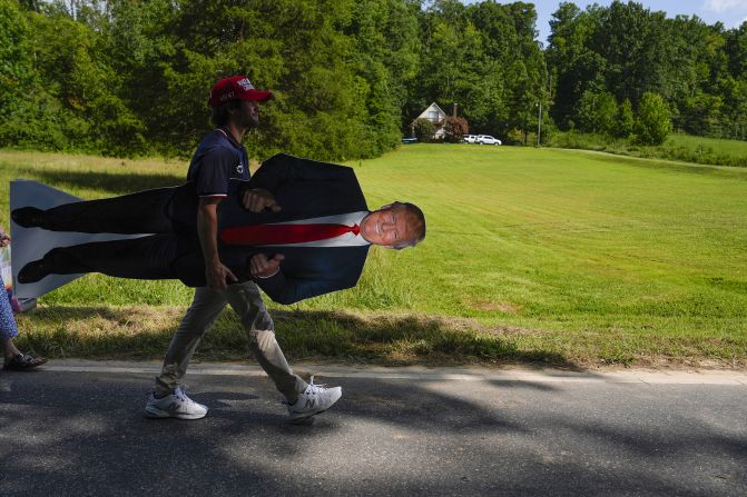 A Trump supporter carries a Trump standup after a campaign rally in Asheboro, North Carolina, on August 21.