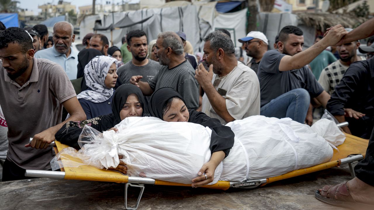 Palestinian women mourn a relative killed in the Israeli bombardment of the Gaza Strip, at a hospital in Deir al-Balah, on August 22.