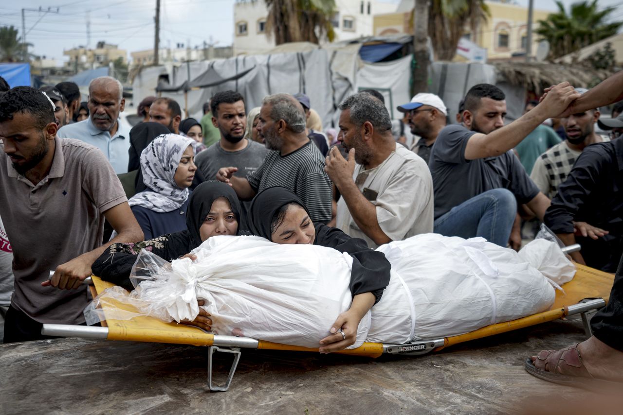 Palestinian women mourn a relative killed in the Israeli bombardment of the Gaza Strip, at a hospital in Deir al-Balah, on August 22.