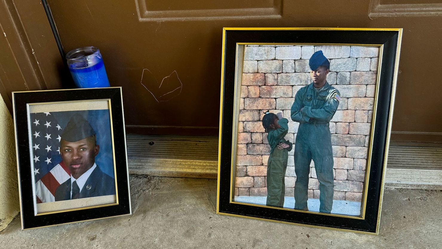 Candles and framed photos of Roger Fortson, a US Air Force senior airman who was fatally shot by a Florida sheriff's deputy in May, sit Friday in the doorway of the apartment where he was killed.