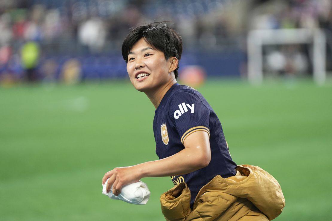 Ji throws a t-shirt into the crowd after the match as the team celebrates an unforgettable evening.