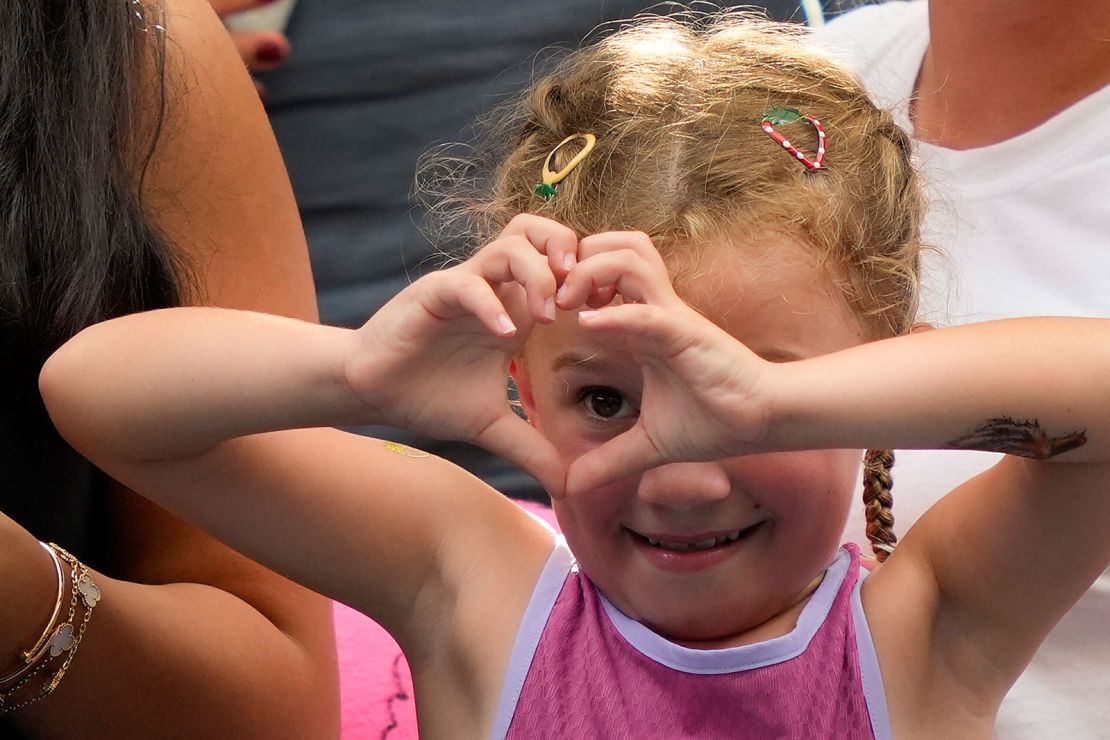 The young tennis fan motions to Sabalenka after the match.