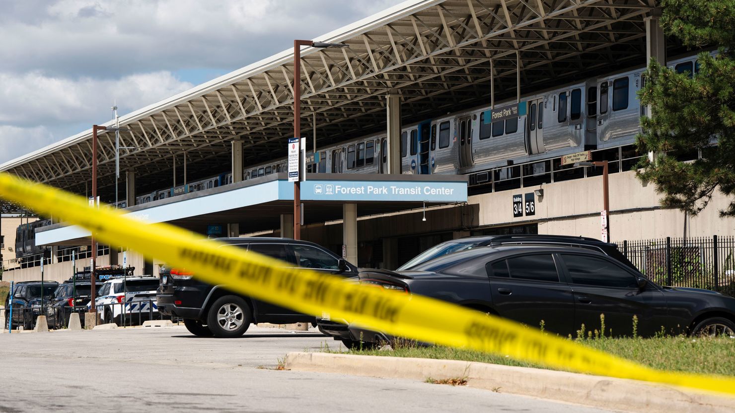 Yellow tape blocks off the parking lot of the Forest Park Blue Line train station in Forest Park, Illinois, after four people were fatally shot on a train early Monday.