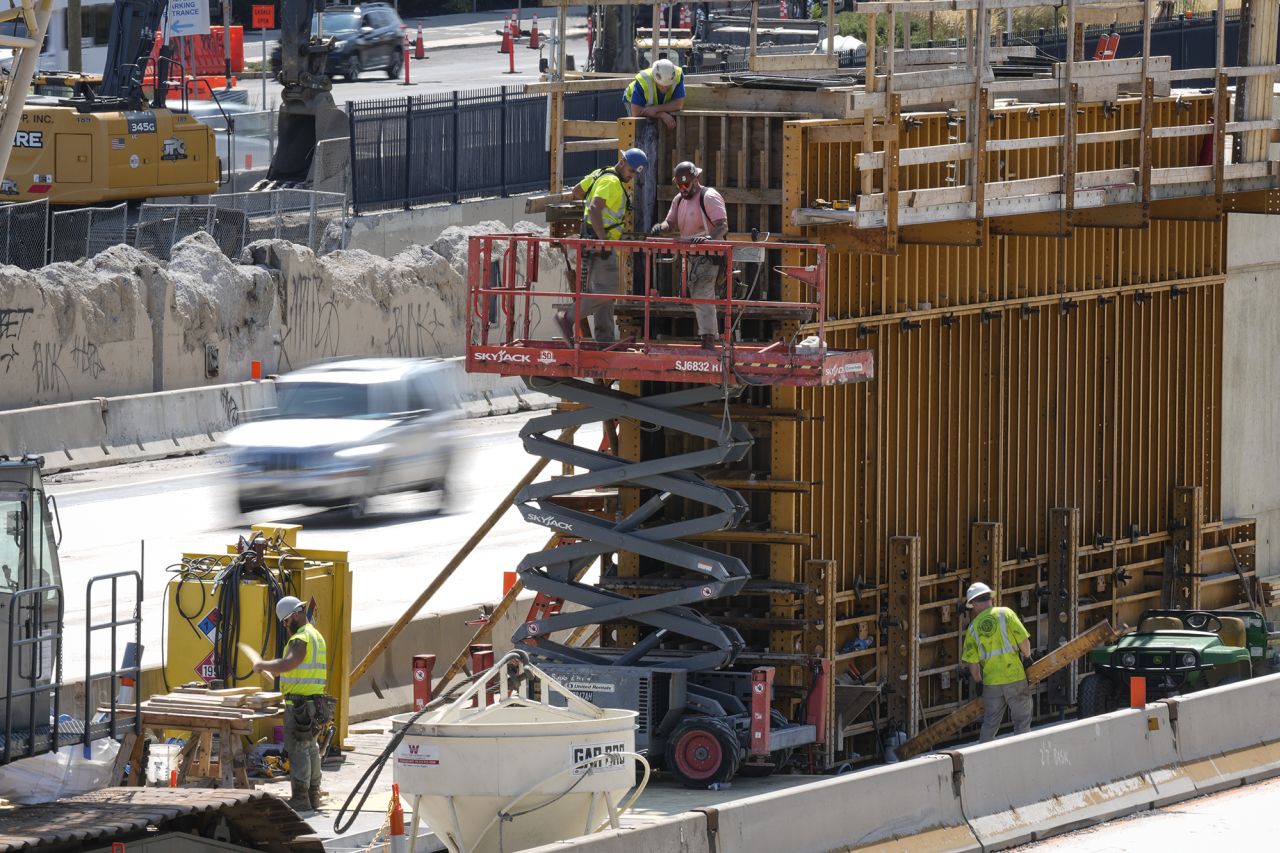 Construction workers build a structure along Interstate 95 in Philadelphia on September 3.