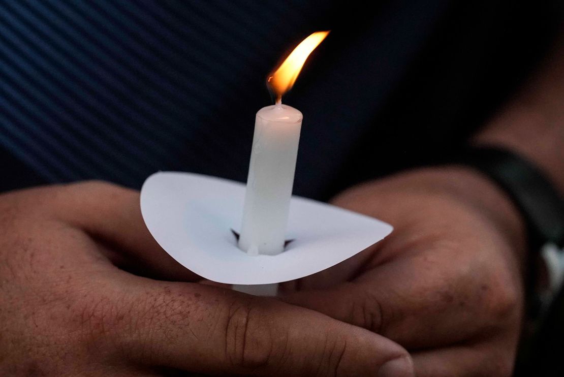 Mark Gorman holds a candle during a vigil Wednesday for the slain students and teachers at Apalachee High School.