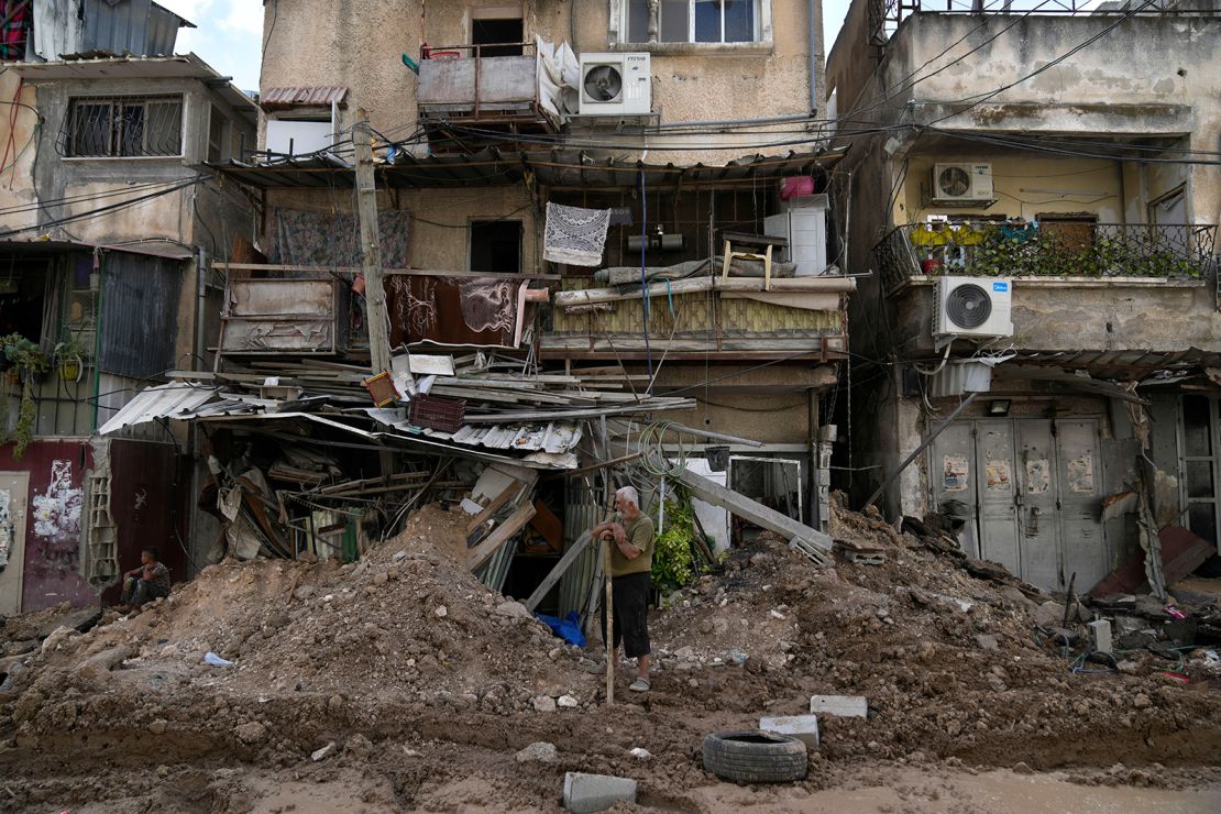 A Palestinian refugee stands in front of his shop that was partly destroyed during the Israeli army operation in Tulkarem, West Bank, on Thursday.