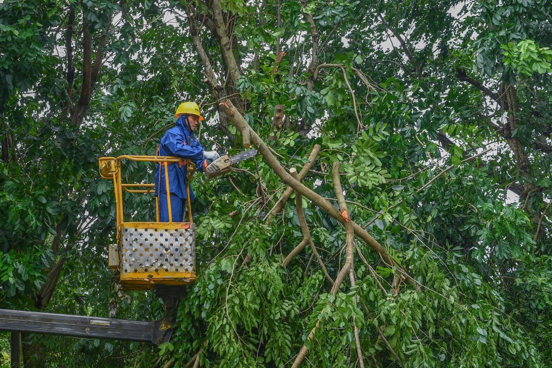 A staff member cuts branches of fallen trees in Haikou, Hainan Province of China on September 6, 2024.