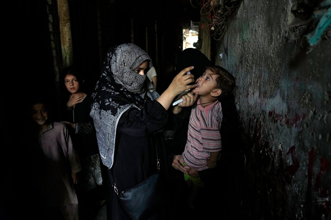 A health worker administers a polio vaccine to a child in a downtown area of Lahore, Pakistan, on September 9, 2024.