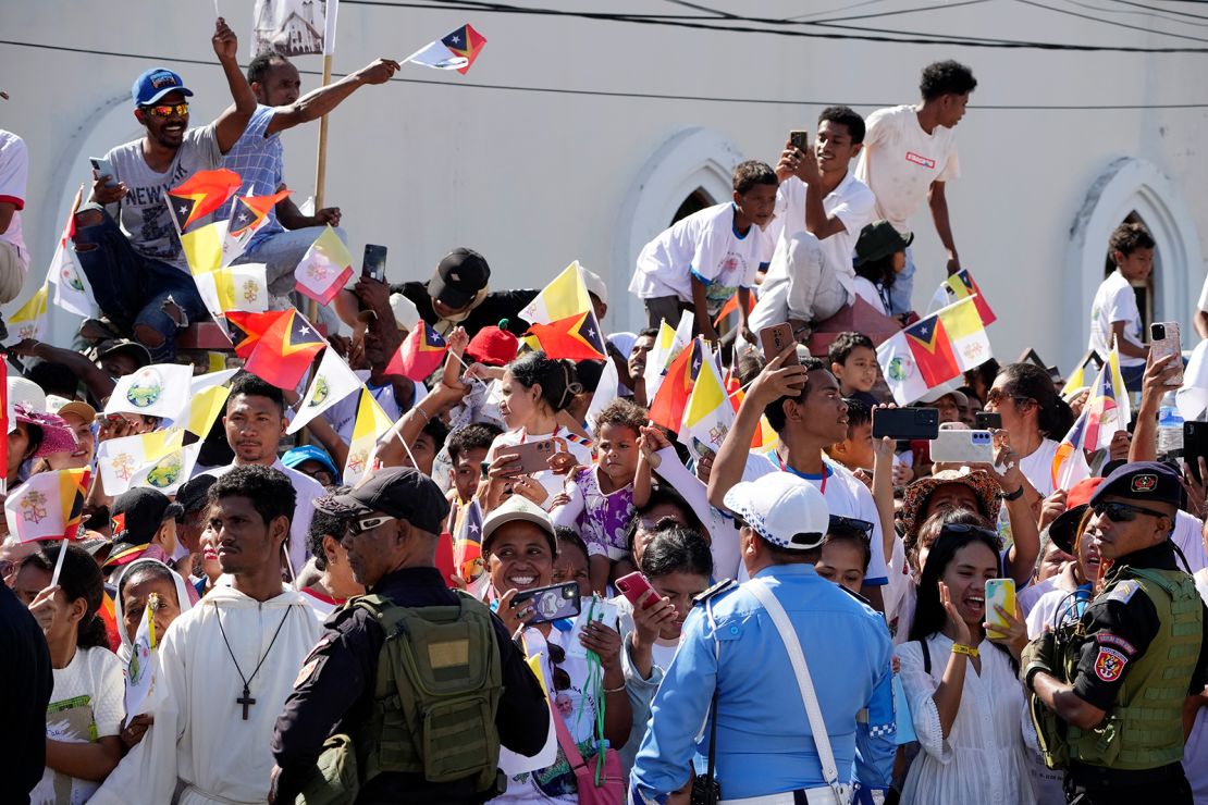 People wait for Pope Francis to arrive at the Cathedral of the Immaculate Conception in Dili, East Timor, on September 10, 2024.