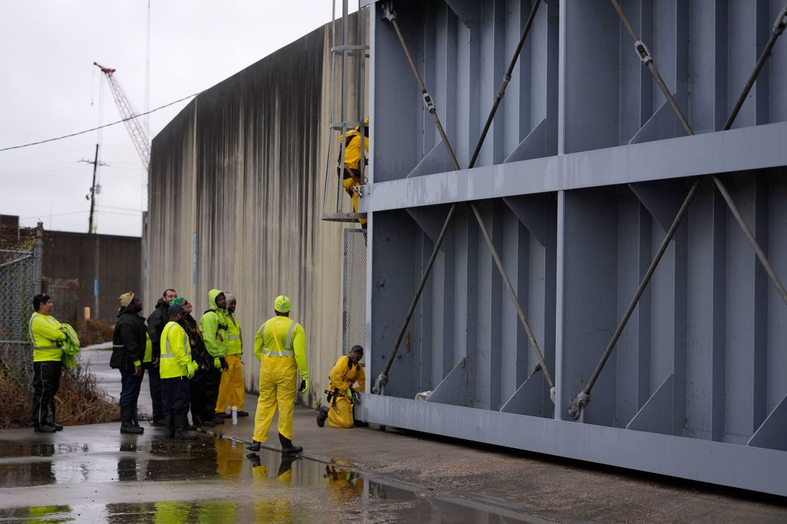 Workers close floodgates along the Harvey Canal, just outside the New Orleans city limits, in anticipation of Tropical Storm Francine, in Harvey, Louisiana, on Tuesday.