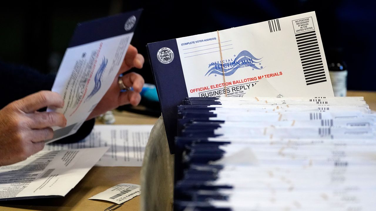 Election workers process mail-in and absentee ballots in West Chester, Pennsylvania, on November 4, 2020.