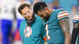 Miami Dolphins quarterback Tua Tagovailoa (right) walks off the field with head coach Mike McDaniel after suffering an injury during the game against the Buffalo Bills.