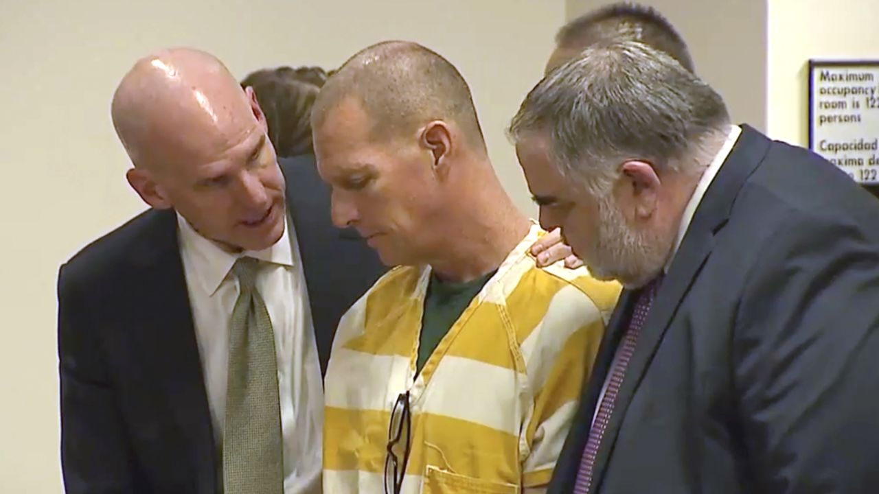 FILE - Lawyers console paramedic Peter Cichuniec after his sentence is read, March 1, 2024, in Brighton, Colo. (Colorado State Court via AP, Pool, File)