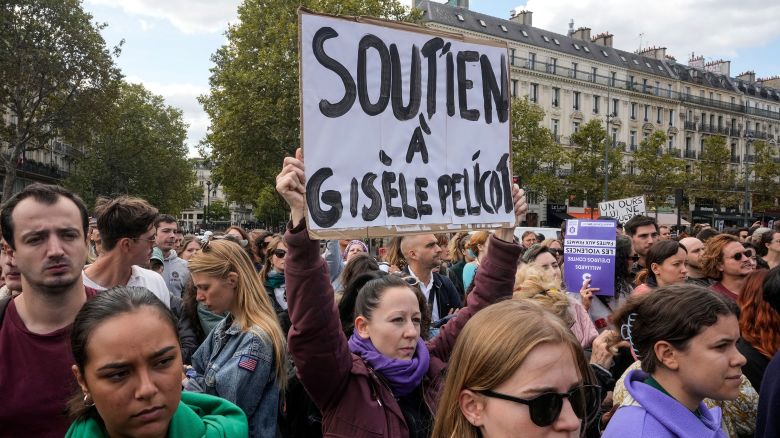 People take part in a gathering in support of 71-year-old Gisele Pelicot who was allegedly drugged by her ex-husband and raped by dozens of men while unconscious, Saturday, Sept. 14, 2024 in Paris. Placard reads, "support for Gisle Pelicot."