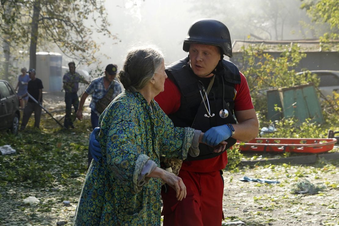 An elderly woman is assisted after a Russian aerial bomb struck a multi-story residential building in Kharkiv, Ukraine, Sunday Sept. 15, 2024.