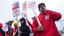 Boeing wing mechanic lead Lee Lara, who has worked for the company for 16 years, yells in response to honks from passing drivers as workers wave picket signs while striking.