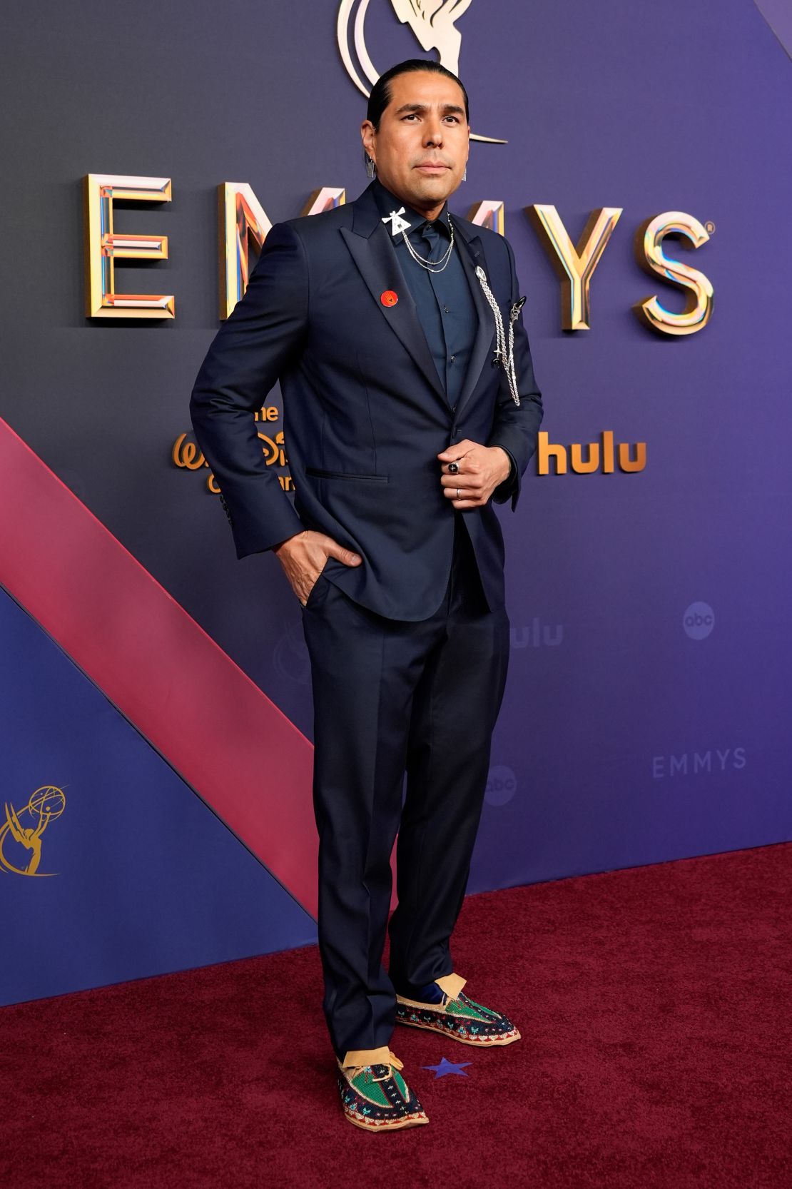 Activist and actor Dallas Goldtooth in a navy Canali tuxedo with peaked lapels.