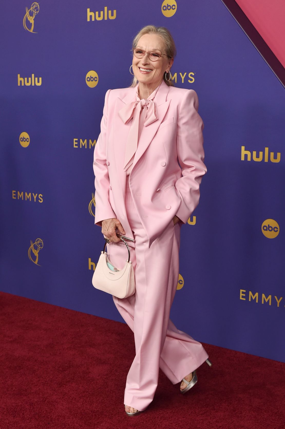 Meryl Streep, one of several attendees opting for pink, wore a pantsuit with pussy bow blouse.