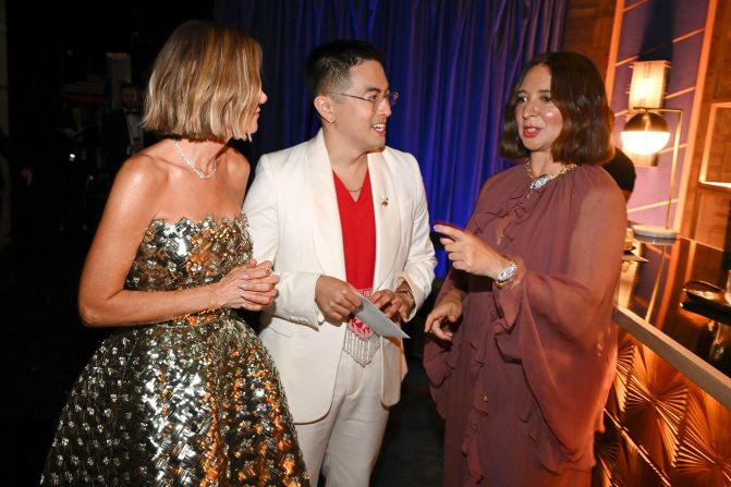 From left, Kristin Wiig, Bowen Yang and Maya Rudolph — cast members of "Saturday Night Live" past and present — chat backstage.