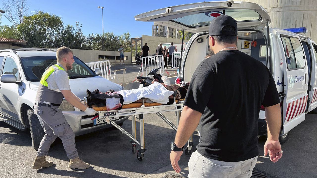 Civil Defense first-responders carry a wounded man whose handheld pager exploded at al-Zahraa hospital in Beirut, Lebanon, Tuesday, Sept. 17, 2024. (AP Photo/Hussein Malla)