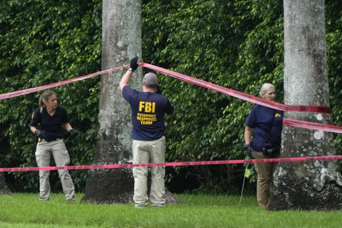 Law enforcement officials work at the scene of the Trump International Golf Club in West Palm Beach, Florida, on September 17. The FBI was investigating what it said was <a href="https://www.cnn.com/2024/09/15/politics/donald-trump-safe-shots/index.html">an apparent assassination attempt</a> on Trump — the second time in two months there’s been an apparent attempt on his life. Trump, who was playing golf at the time, was not harmed. A Secret Service agent spotted a rifle barrel with a scope sticking out of the fence of the golf course and “immediately engaged” with the person, firing shots at the man, Palm Beach County Sheriff Ric Bradshaw said.