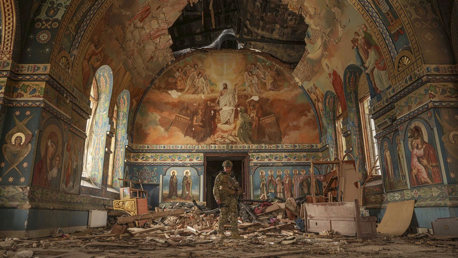 A Ukrainian serviceman stands inside an Orthodox church heavily damaged by Russian bombardment in Novoekonomichne, in eastern Ukraine, on September 17, 2024.