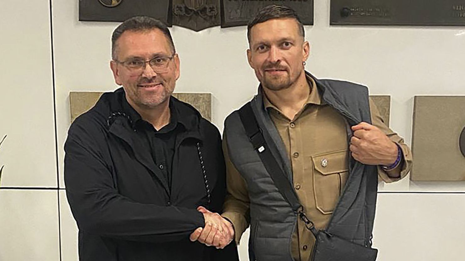 Heavyweight boxing champion Oleksandr Usyk (right) shakes hands with the Ukrainian Consul General in Krakow, Viacheslav Voinarovskyi, following his release.