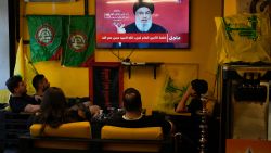 People watch the speech of Hezbollah leader Hassan Nasrallah as they sit in a cafe in the southern suburbs of Beirut, Lebanon, on September 19, 2024.