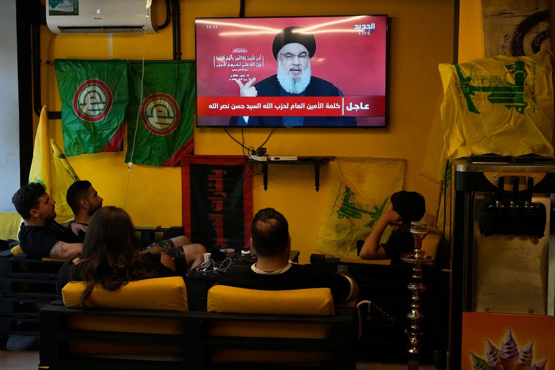 People watch a speech by Hezbollah leader Hassan Nasrallah as they sit in a cafe in the southern suburbs of Beirut, Lebanon, on September 19, 2024.