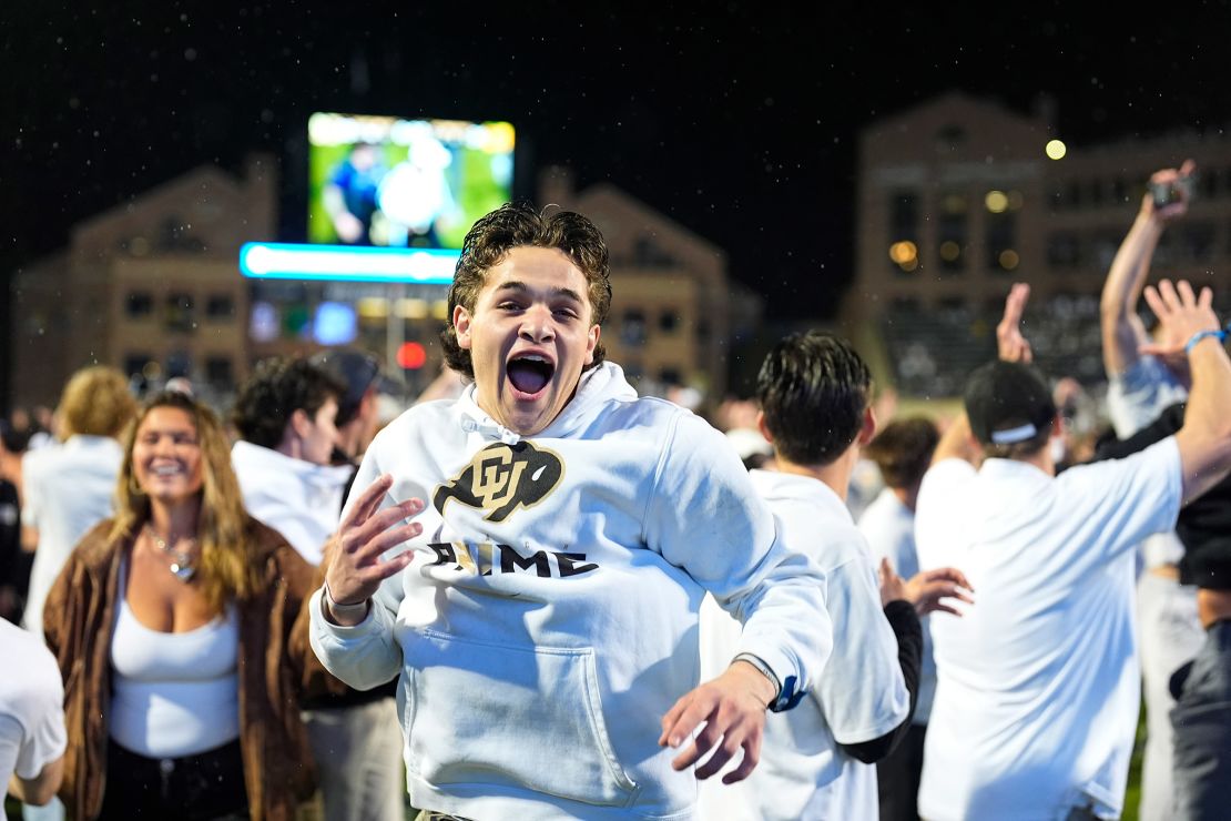 Colorado fans storm the field after the Buffaloes' overtime win over Baylor.