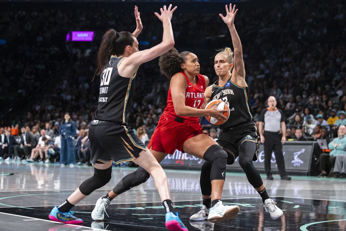 Atlanta Dream defender Haley Jones gets between New York Liberty forwards Breanna Stewart and Leonie Fiebich during the second half.