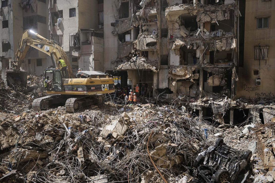 Emergency workers use excavators to clear the rubble at the site of Friday's Israeli strike in Beirut's southern suburbs, Lebanon on Monday, September 23.