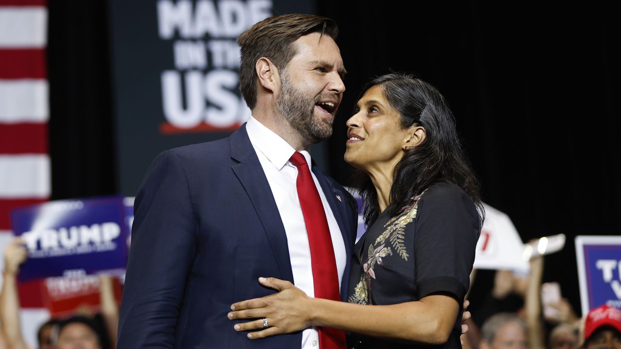 Republican vice presidential nominee Sen. JD Vance, R-Ohio, walks onstage with his wife Usha Vance at a campaign event in Charlotte, N.C., Monday, Sept. 23, 2024. (AP Photo/Nell Redmond)