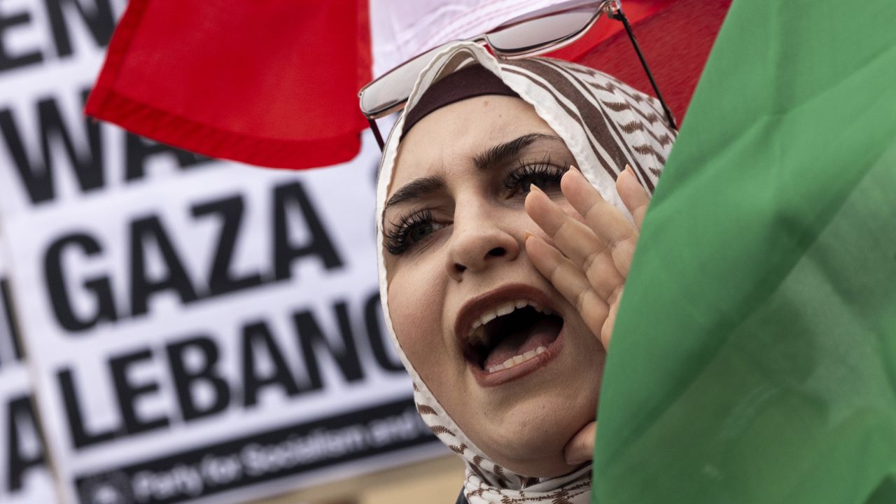 A protester waves a Lebanese flag as demonstrators gather to protest against the war on Gaza and Israeli military strikes on Lebanon in front of the Los Angeles Federal Building on September 24, in Los Angeles, California.