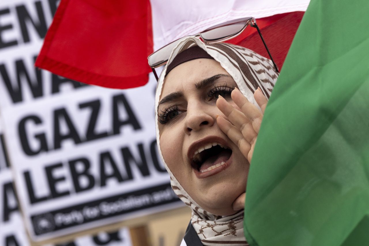 A protester waves a Lebanese flag as demonstrators gather to protest against the war on Gaza and Israeli military strikes on Lebanon in front of the Los Angeles Federal Building on September 24, in Los Angeles, California.