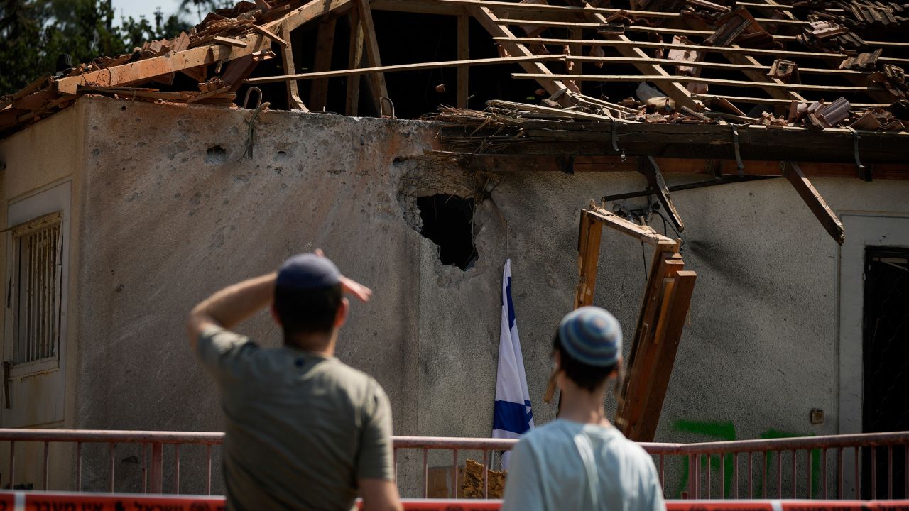 People look at a damaged house that was hit by a rocket fired from Lebanon, near Safed, northern Israel, on September 25, 2024.