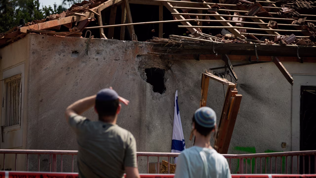 People look at a damaged house that was hit by a rocket fired from Lebanon, near Safed, northern Israel, on September 25, 2024.